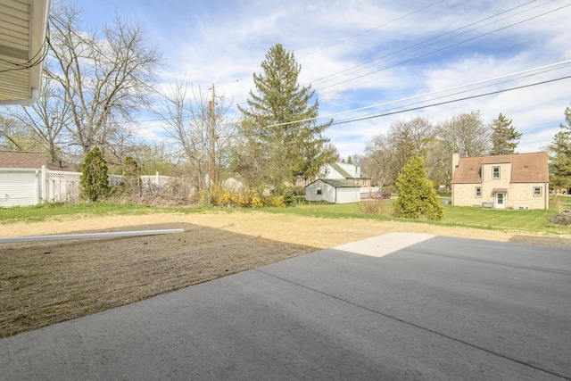 view of yard featuring fence, a residential view, and a patio area