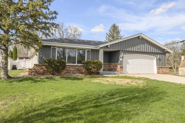 ranch-style house featuring brick siding, driveway, a front yard, and a garage