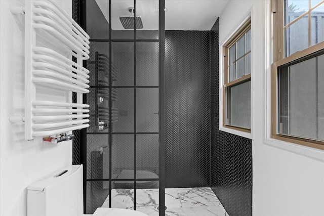2627 N Farwell Ave, Milwaukee, WI 53211 - bathroom with marble finish floors, tiled shower, radiator, a towel warming rack, and toilet