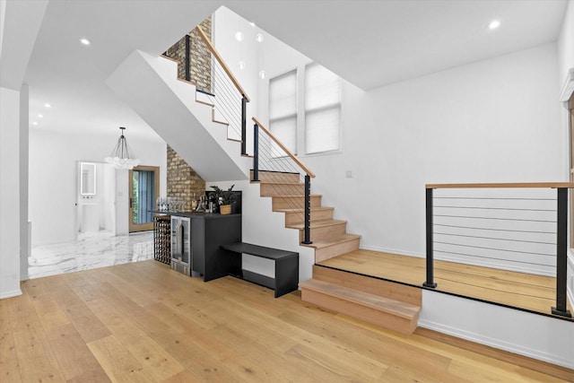 2627 N Farwell Ave, Milwaukee, WI 53211 - stairs featuring recessed lighting, a chandelier, wood finished floors, and baseboards