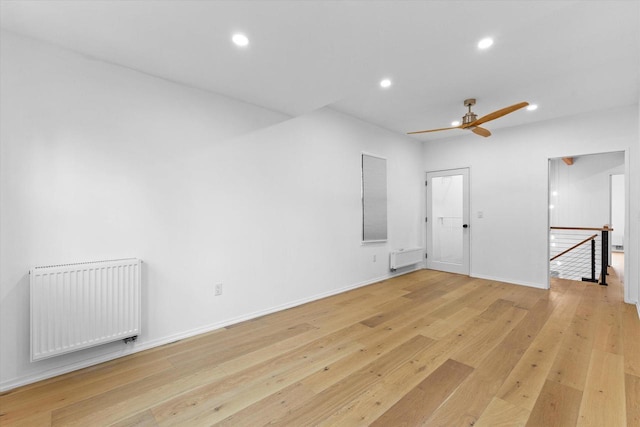 2627 N Farwell Ave, Milwaukee, WI 53211 - unfurnished room featuring radiator, recessed lighting, light wood finished floors, ceiling fan, and baseboards