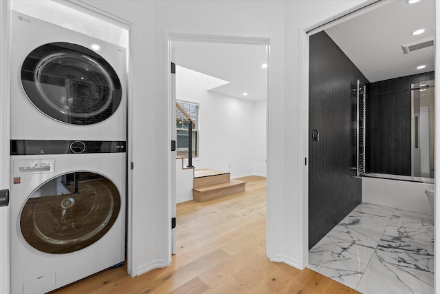 2627 N Farwell Ave, Milwaukee, WI 53211 - laundry area featuring stacked washing machine and dryer, recessed lighting, and baseboards