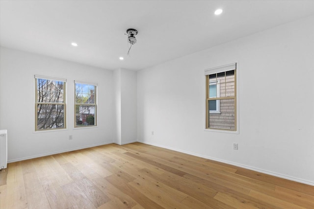 2627 N Farwell Ave, Milwaukee, WI 53211 - spare room with light wood finished floors, recessed lighting, baseboards, and radiator heating unit