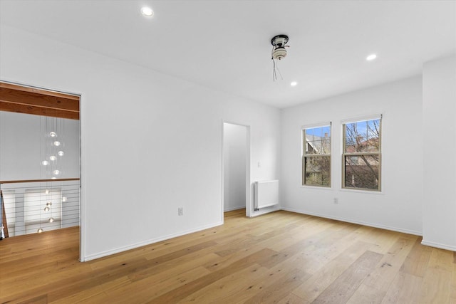 2627 N Farwell Ave, Milwaukee, WI 53211 - empty room featuring radiator, light wood-style flooring, recessed lighting, and baseboards