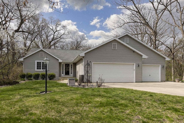 view of front of property with a garage, central AC, driveway, and a front yard