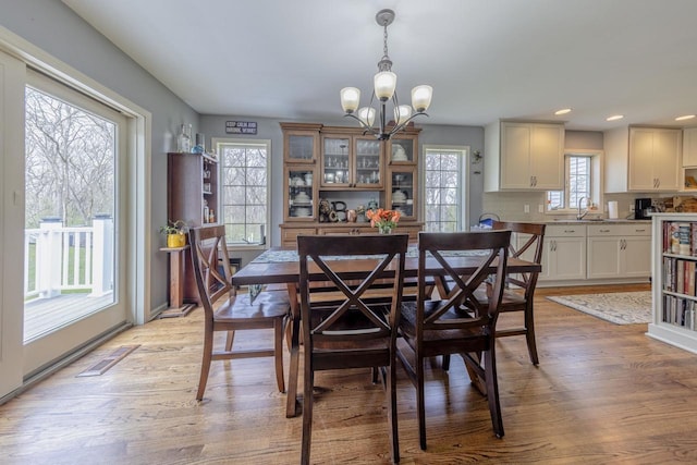 dining area with recessed lighting, a notable chandelier, light wood finished floors, and visible vents