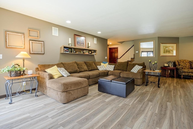 living area featuring recessed lighting, light wood finished floors, and stairs