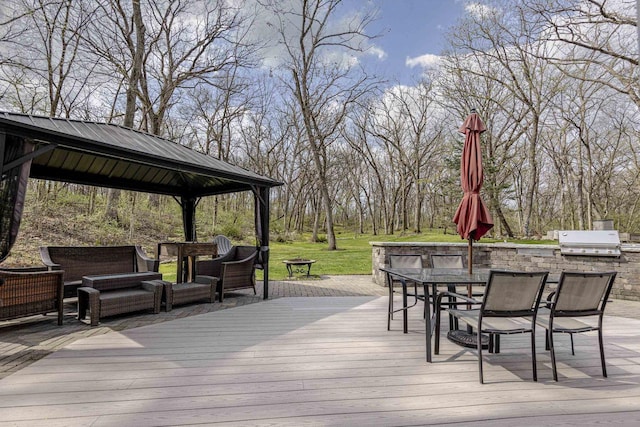 wooden terrace with area for grilling, a gazebo, an outdoor hangout area, an outdoor kitchen, and outdoor dining space