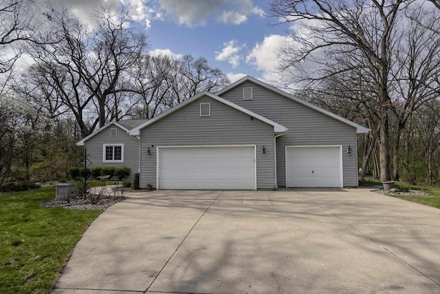 ranch-style house with an attached garage, a front lawn, and driveway