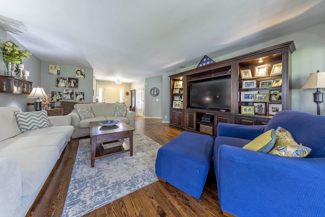 living area featuring baseboards and wood finished floors