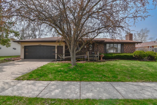 ranch-style house featuring a chimney, a front yard, a garage, brick siding, and concrete driveway