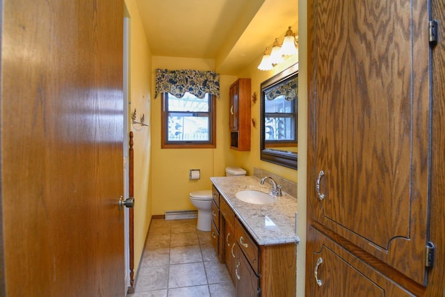 bathroom with tile patterned flooring, vanity, toilet, baseboards, and visible vents
