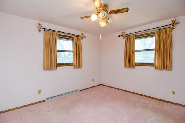 spare room featuring baseboards, carpet flooring, ceiling fan, and baseboard heating