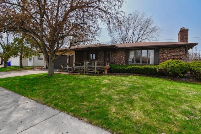 ranch-style home featuring a chimney, an attached garage, driveway, and a front yard