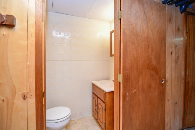 half bathroom with toilet and vanity