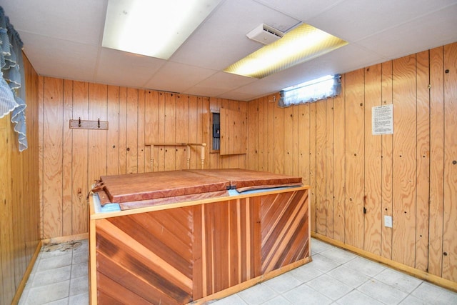 bar with wooden walls, baseboards, and light tile patterned floors