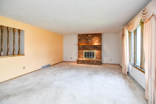 unfurnished living room featuring carpet flooring, visible vents, plenty of natural light, and a fireplace