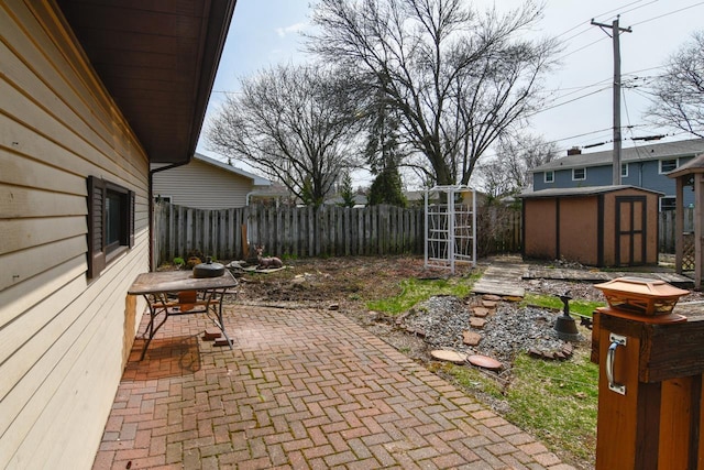 view of yard featuring an outdoor structure, a patio area, fence, and a shed