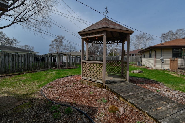 view of yard with a fenced backyard, a gazebo, and cooling unit