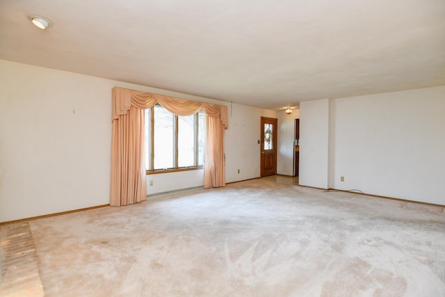 empty room with baseboards and light colored carpet