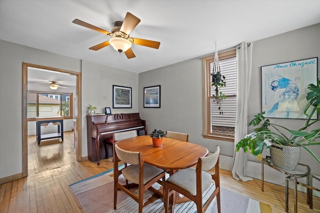dining area featuring ceiling fan, a healthy amount of sunlight, and light wood-type flooring