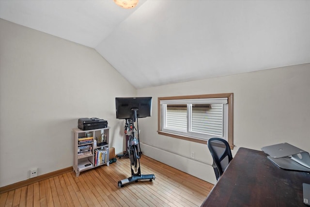 home office with baseboards, vaulted ceiling, and hardwood / wood-style flooring