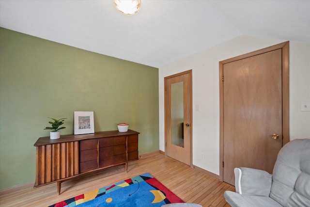 interior space with baseboards and wood finished floors