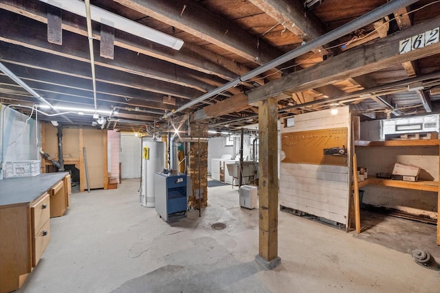 basement featuring a heating unit, gas water heater, and washing machine and clothes dryer