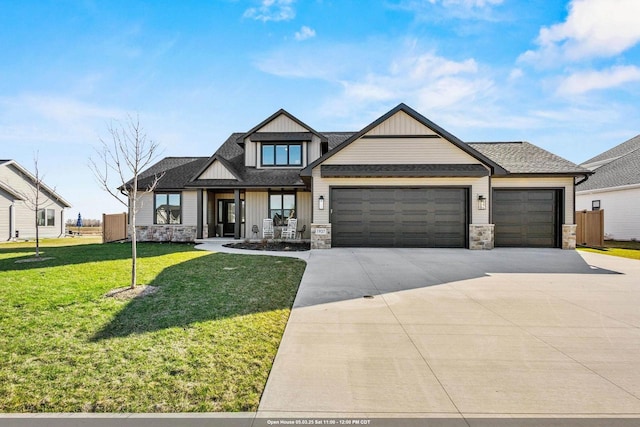 craftsman-style house with a garage, concrete driveway, a front lawn, and stone siding