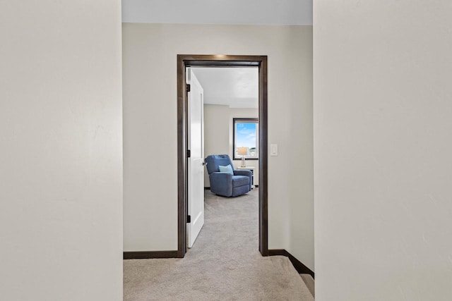 corridor featuring carpet flooring and baseboards