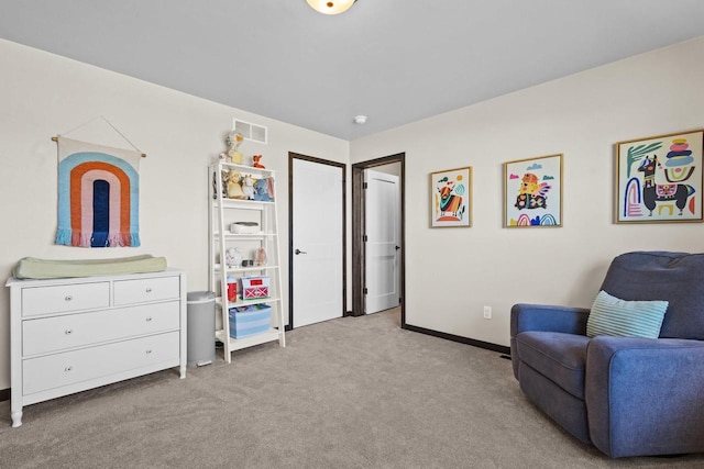 sitting room with baseboards, light carpet, and visible vents