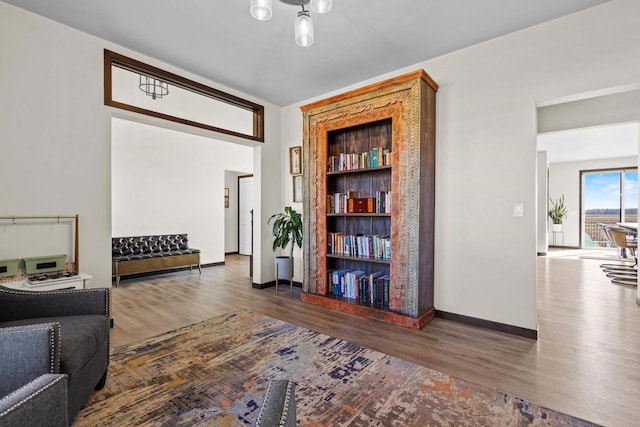 sitting room featuring baseboards and wood finished floors
