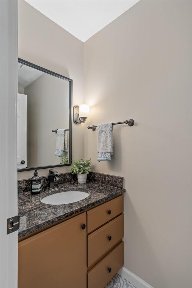bathroom with vanity and baseboards