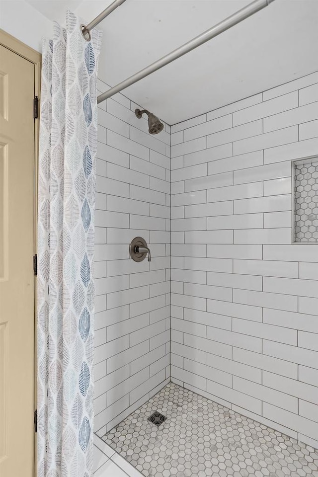 full bath with a shower stall