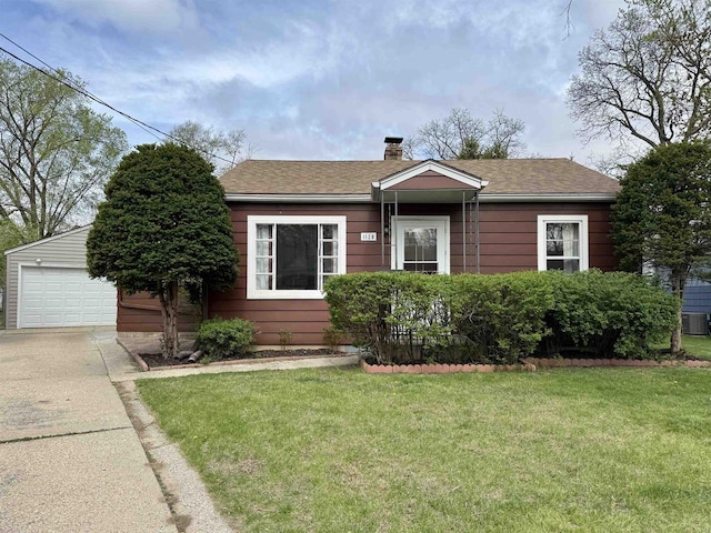 bungalow-style house featuring a chimney, a garage, an outdoor structure, a front lawn, and concrete driveway