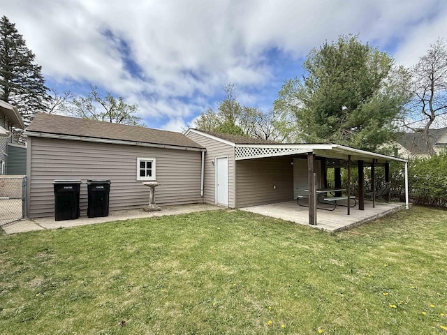 rear view of property with a lawn and a patio