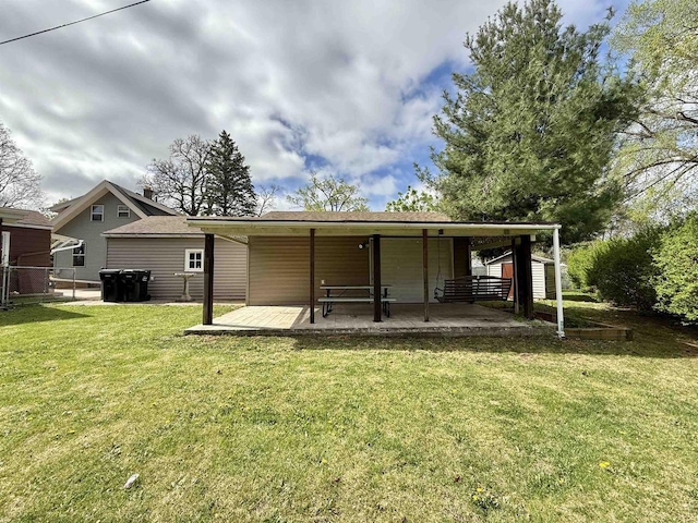 back of house with fence and a yard