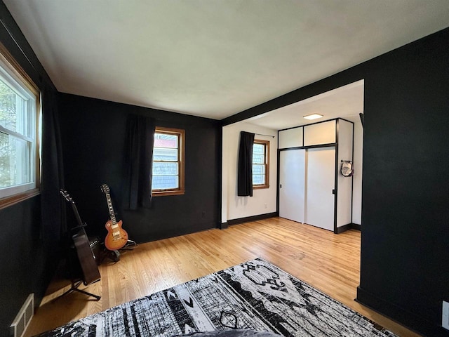 bedroom featuring light wood-style floors, baseboards, and visible vents