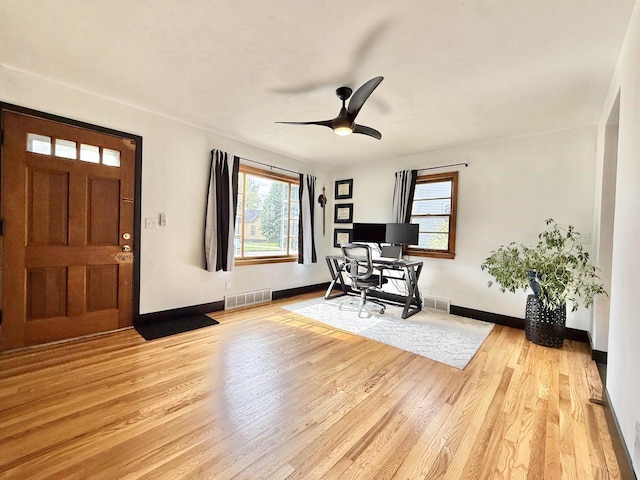office with visible vents, baseboards, ceiling fan, and wood finished floors