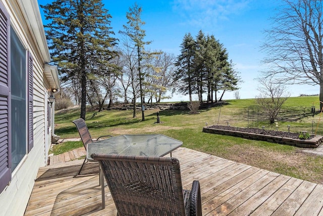 deck with a lawn and outdoor dining area