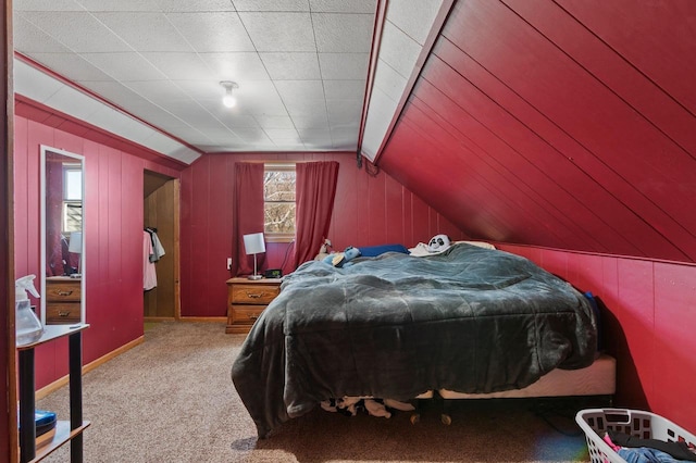bedroom with carpet flooring, lofted ceiling, and wooden walls