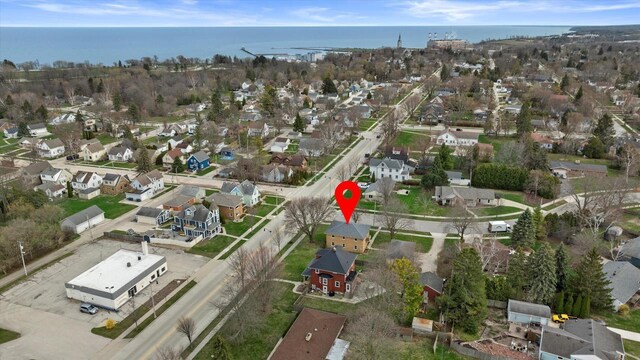 birds eye view of property with a water view and a residential view