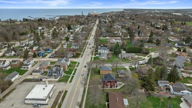 bird's eye view featuring a water view and a residential view