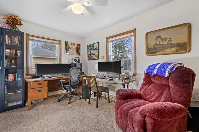 home office featuring light colored carpet and a ceiling fan