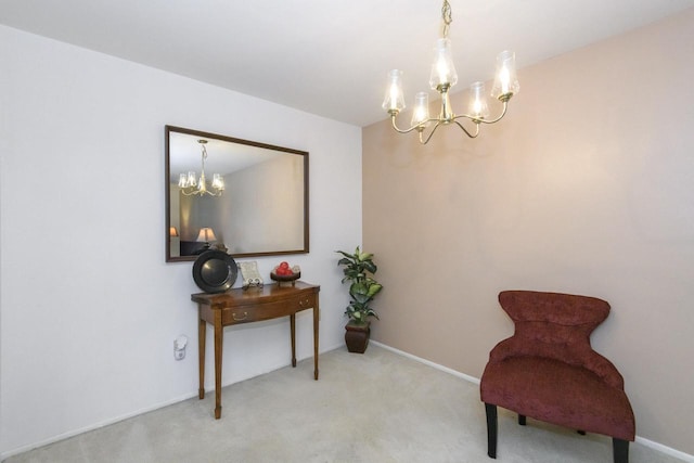 living area featuring carpet flooring, baseboards, and an inviting chandelier