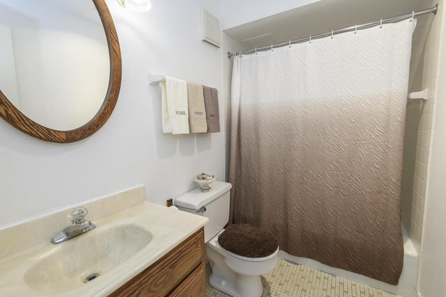 bathroom featuring vanity, tile patterned flooring, and toilet