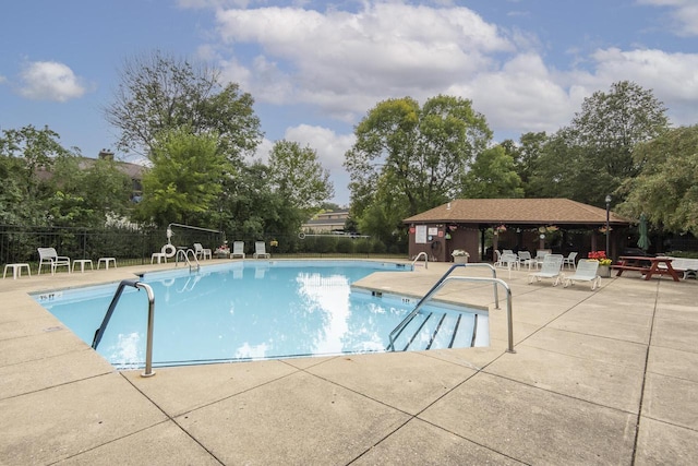 pool with a gazebo, a patio area, and fence
