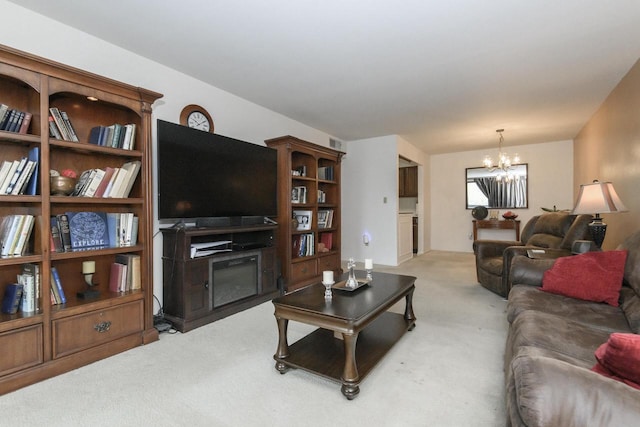 living area with a notable chandelier and light colored carpet