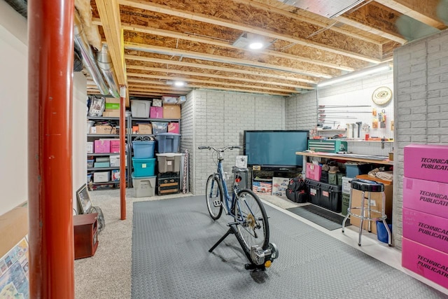 exercise area featuring a workshop area and brick wall