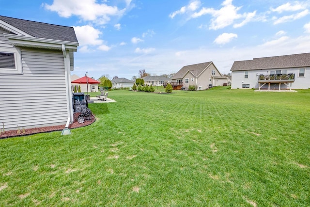 view of yard featuring a patio and a residential view